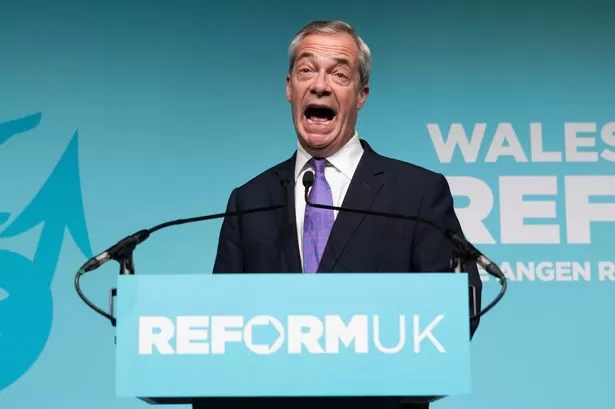 Nigel Farage mocks woman as she's escorted from Reform event in Wales