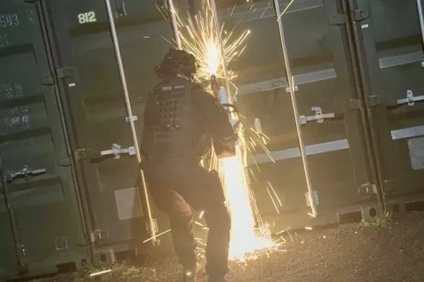 Police break open secure container and discover major haul inside