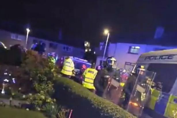Fireworks flung at police as angry mob gathered outside paedophile's home